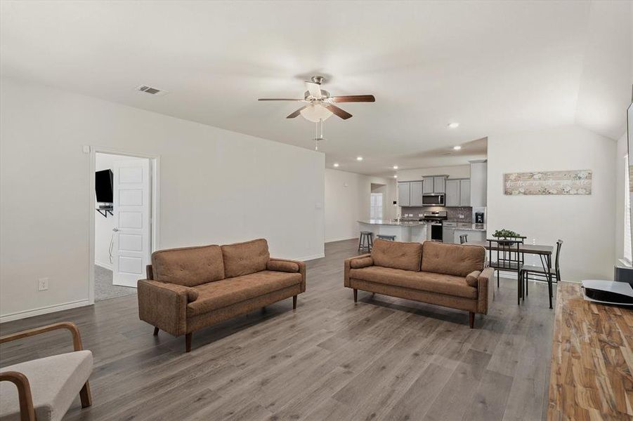 Living room with ceiling fan, dark wood-style floors, and recessed lighting Living room with ceiling fan, dark wood-style floors, and recessed lighting