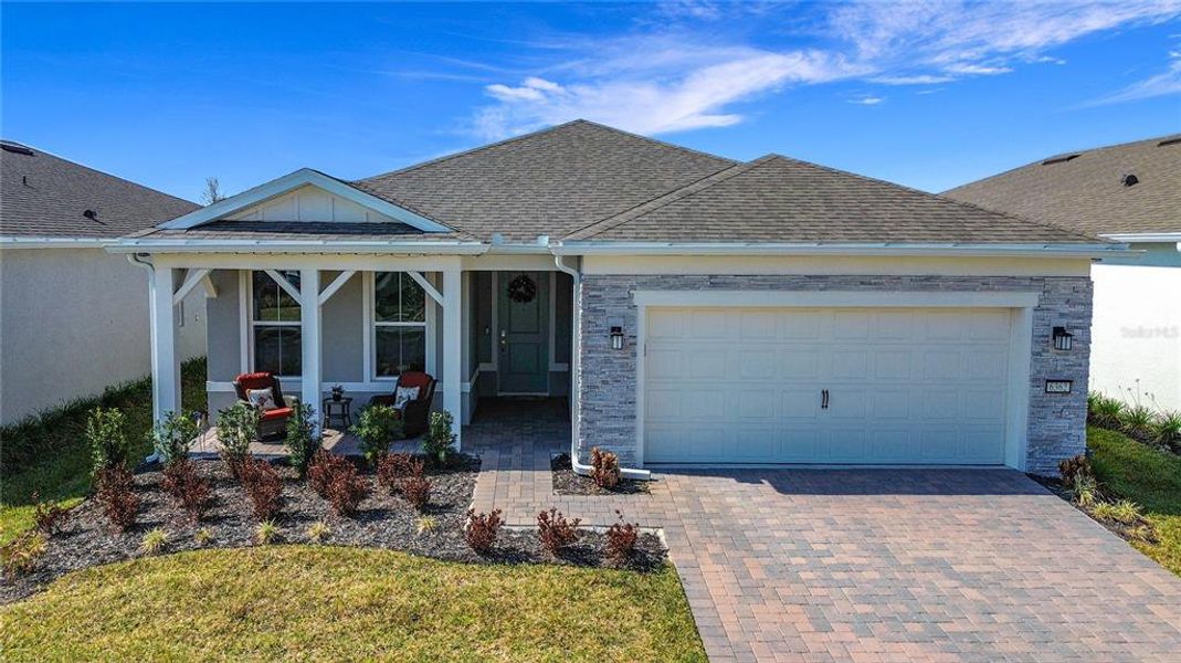 Front exterior of a new home in Del Webb Sunbridge, St. Cloud, FL, highlighting curb appeal (Image 2). Front exterior of a new home in Del Webb Sunbridge, St. Cloud, FL, highlighting curb appeal (Image 2).