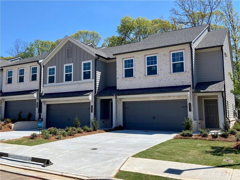 Front exterior of a new home in Eastlyn Crossing, Flowery Branch, GA, highlighting curb appeal (Image 1). Front exterior of a new home in Eastlyn Crossing, Flowery Branch, GA, highlighting curb appeal (Image 1).