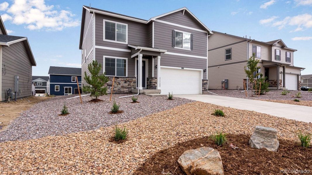 Front exterior of a new home in Spring Valley Ranch, Elizabeth, CO, highlighting curb appeal (Image 1).
