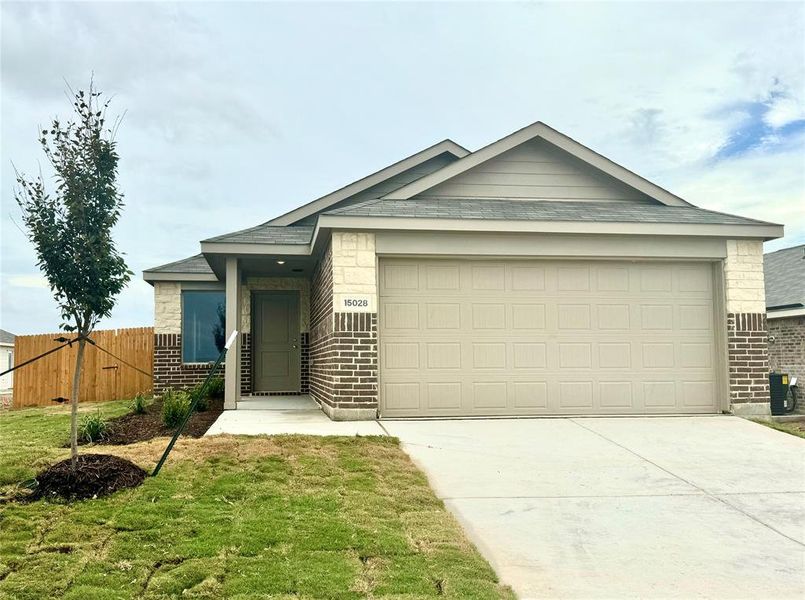 View of front of home featuring a garage and a front lawn