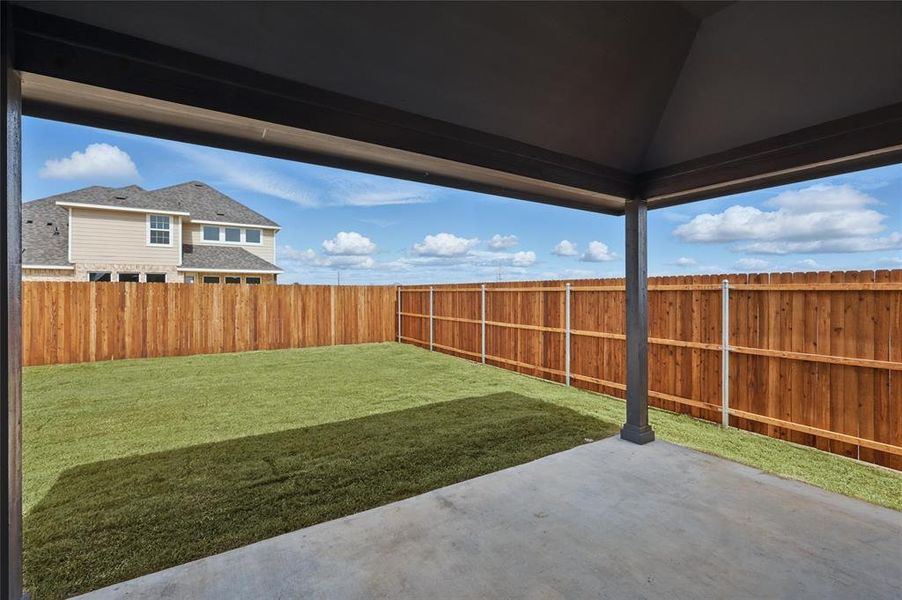 Fenced backyard with a patio area