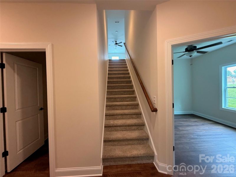 Carpeted stairs lead to the third bedroom...