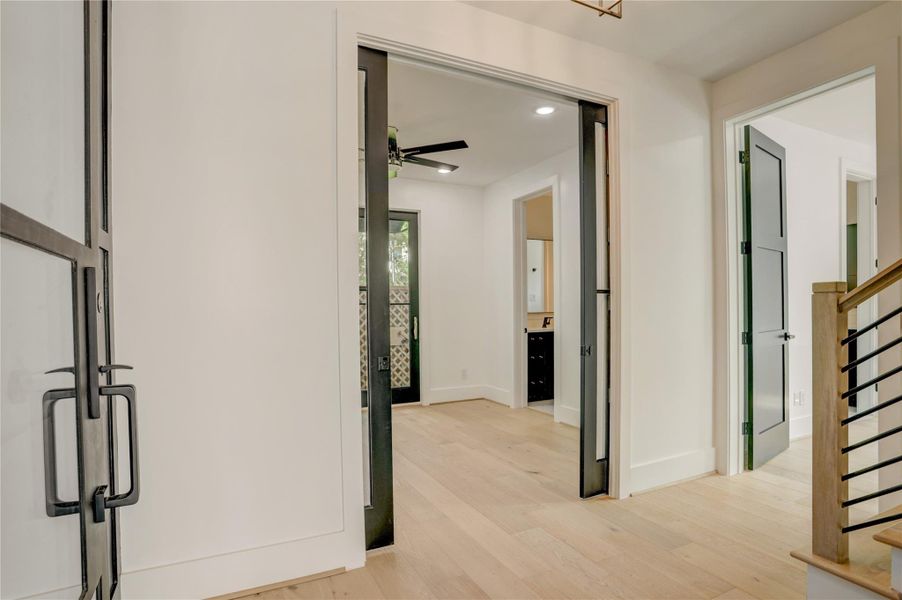 View as the enter the foyer, looking at the glass French door study/bedroom 4 and first-floor guest suite to the right. View as the enter the foyer, looking at the glass French door study/bedroom 4 and first-floor guest suite to the right.