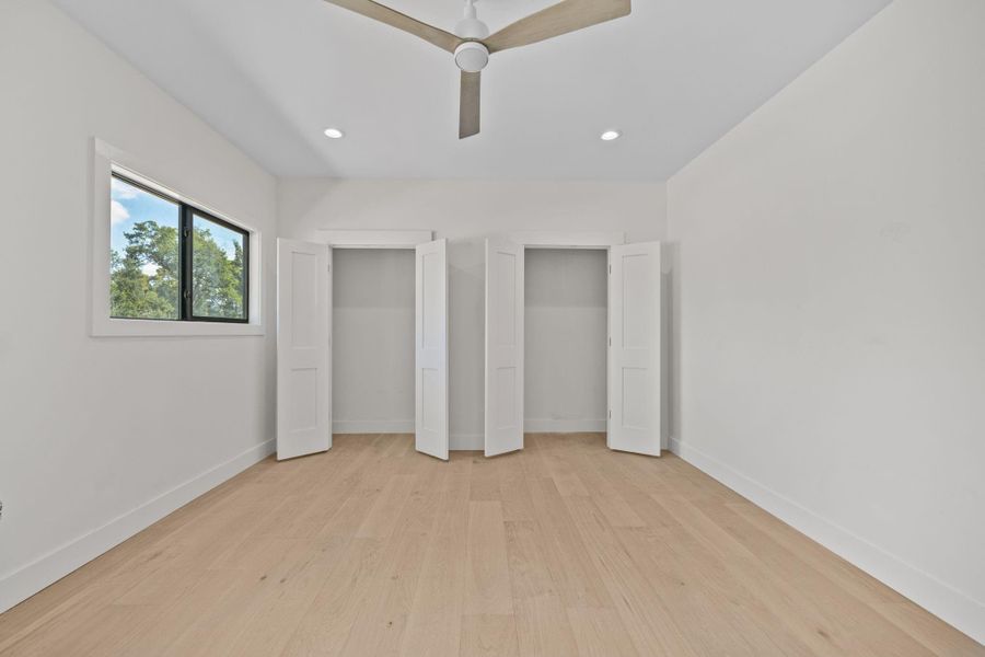 A beautifully appointed bedroom designed with a sophisticated contemporary aesthetic. Warm-toned hardwood flooring creates inviting foundation, while expansive windows fill the space with natural lights.Generous double-door closets providing exceptional storage .Clean architectural lines, soft neutral tones and airy open feel create an elegant private retreat that blends comfort, style and functionality.