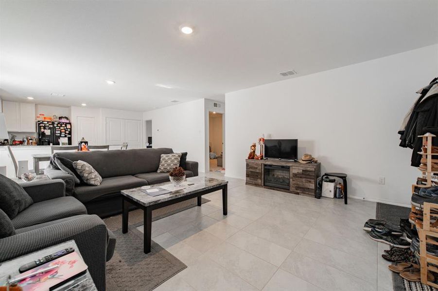 Living area with recessed lighting and light tile patterned floors