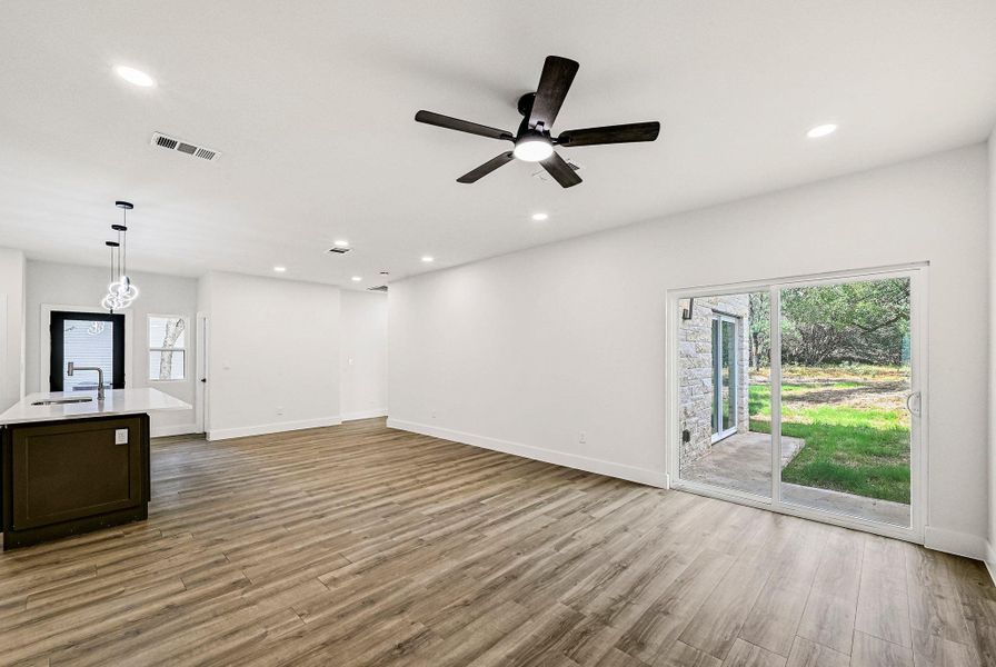 Unfurnished living room with light wood-style floors, recessed lighting, and a ceiling fan