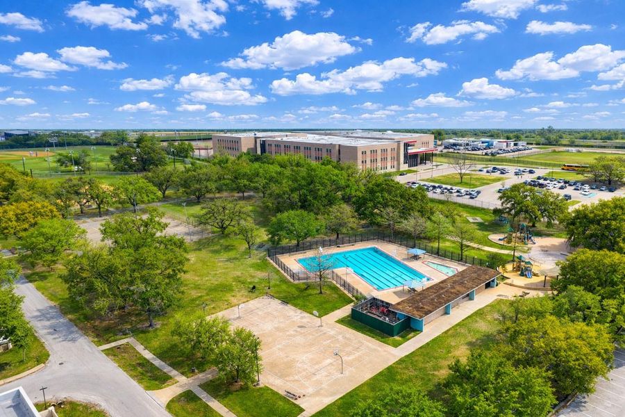 Aerial view of Schwartz Park showcasing expansive green space, walking paths, recreational amenities, and the community pool area just minutes from The Estates at Hollister St. A perfect blend of outdoor recreation and neighborhood convenience.