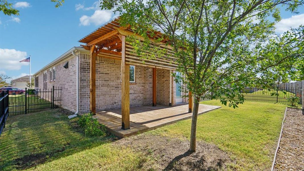 View of side of home with a fenced backyard, brick siding, a patio area, and a pergola View of side of home with a fenced backyard, brick siding, a patio area, and a pergola