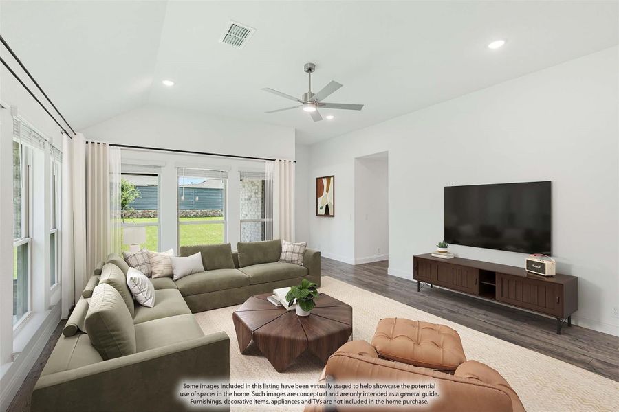 Living room with vaulted ceiling, ceiling fan, hardwood floors, and large windows overlooking backyard Living room with vaulted ceiling, ceiling fan, hardwood floors, and large windows overlooking backyard