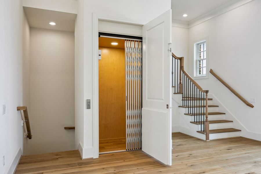 Back inside, the installed elevator provides convenient access between all levels of the home.  Let's go up to see the primary suite!