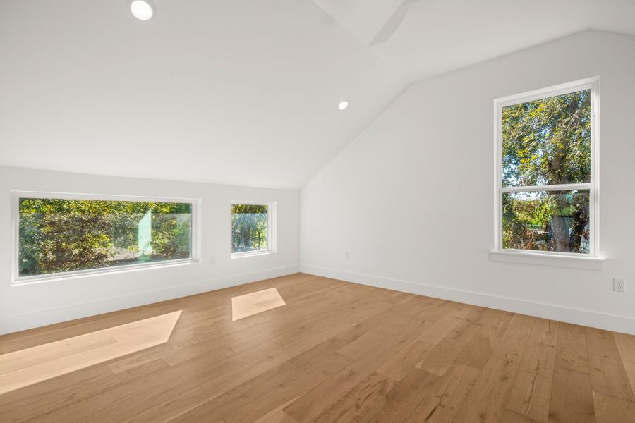 Top floor suite with vaulted ceiling, recessed lighting, and light wood-style flooring Top floor suite with vaulted ceiling, recessed lighting, and light wood-style flooring