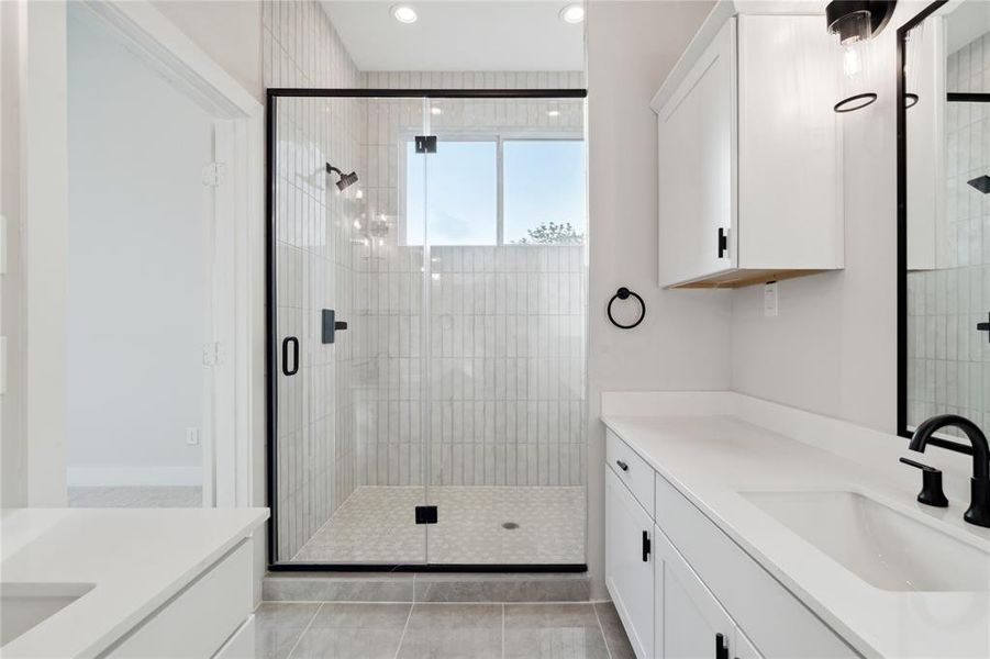 The oversized shower with a sleek frame border gives an accent piece that demands attention.