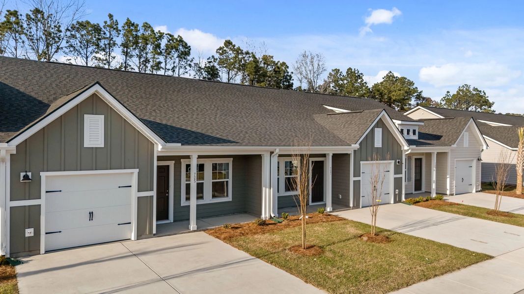 Front exterior of a new home in Blue Heron Retreat, Little River, SC, highlighting curb appeal (Image 17). Front exterior of a new home in Blue Heron Retreat, Little River, SC, highlighting curb appeal (Image 17).