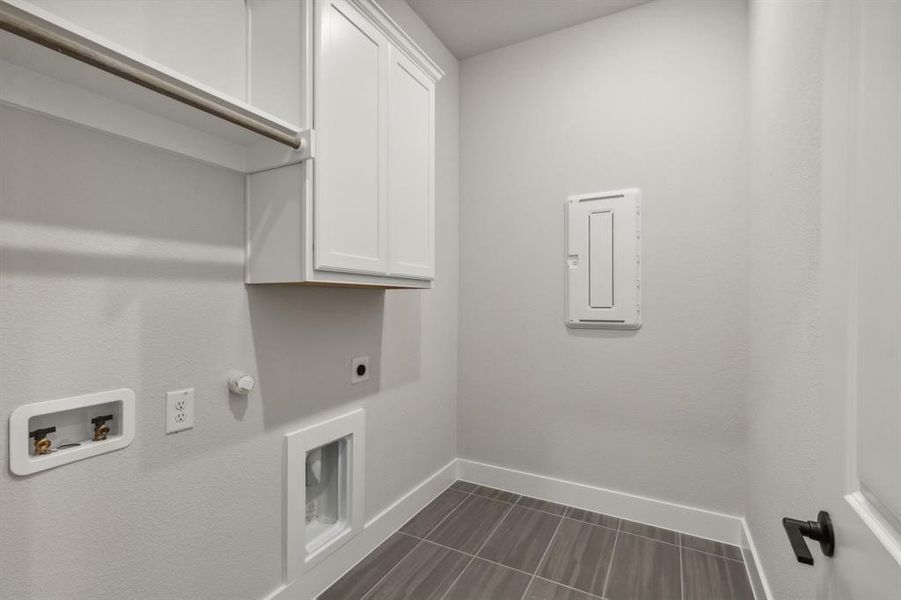 Clothes washing area featuring washer hookup, gas dryer hookup, hookup for an electric dryer, and cabinets