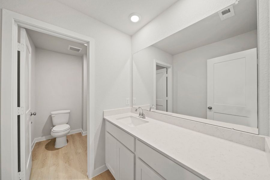 A bathroom with a tub sink and toilet.