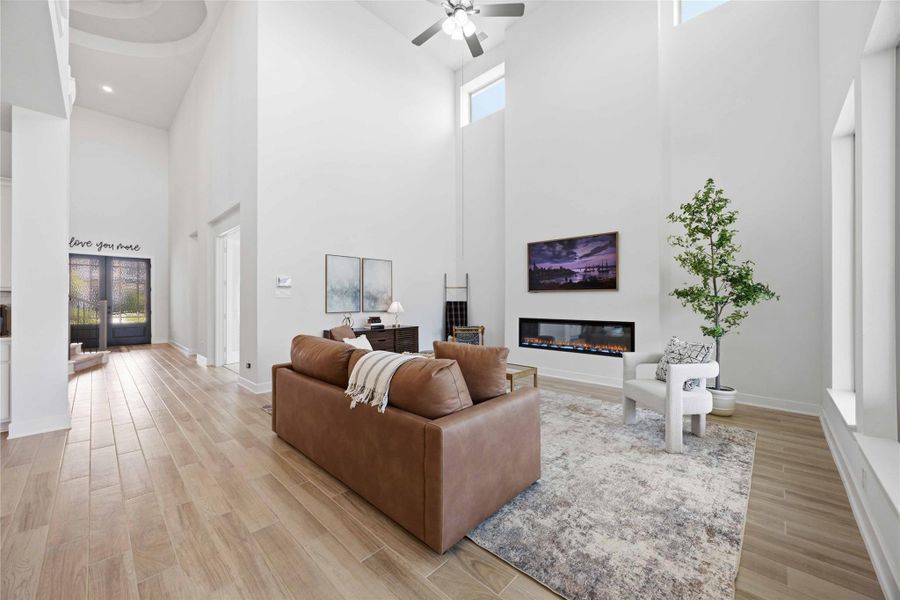 Designed as the centerpiece of the home, this extraordinary living area features soaring ceilings, expansive windows, and an open-concept layout that invites both intimate moments and grand entertaining.