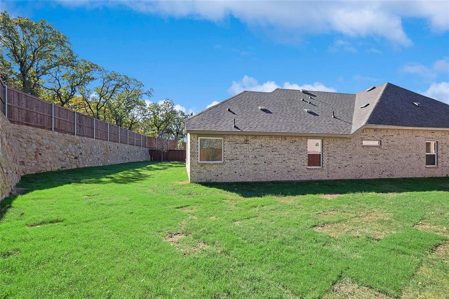 Rear view of house featuring a lawn