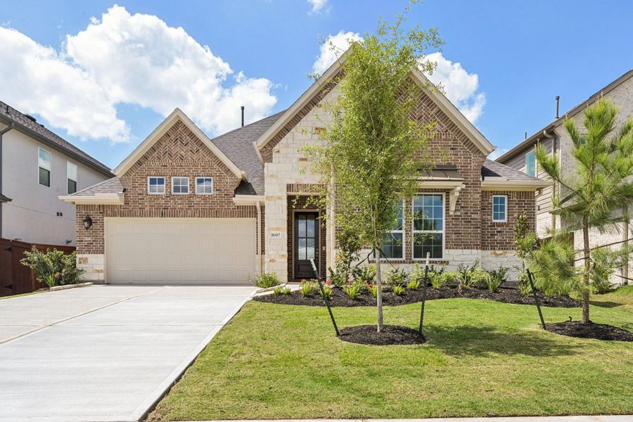 Front exterior of a new home in Evergreen 55', Conroe, TX, highlighting curb appeal (Image 27).