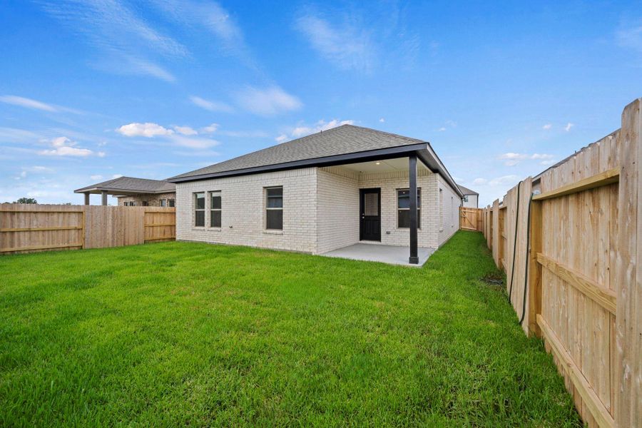 Exterior details and patio area of a home in Windrose Green, Angleton (Image 3).