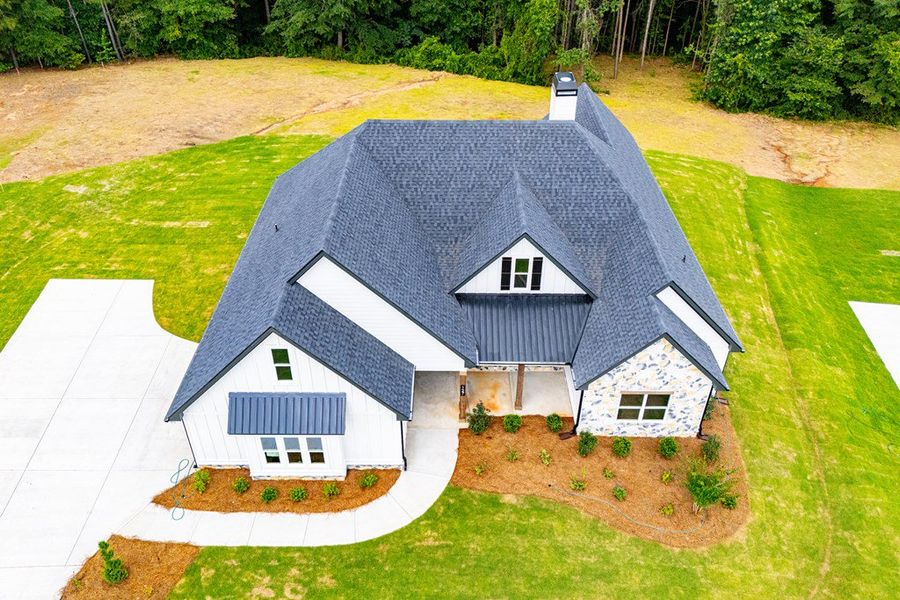 Front exterior of a new home in WOODMONT RESERVE, Roopville, GA, highlighting curb appeal (Image 46).