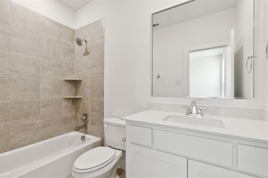 Bathroom featuring a white vanity with a rectangular undermount sink and chrome faucet Bathroom featuring a white vanity with a rectangular undermount sink and chrome faucet