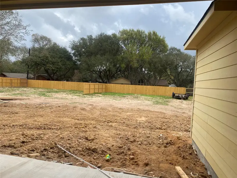 Spacious lot with covered porch with 1/2 bath entry from the porch.