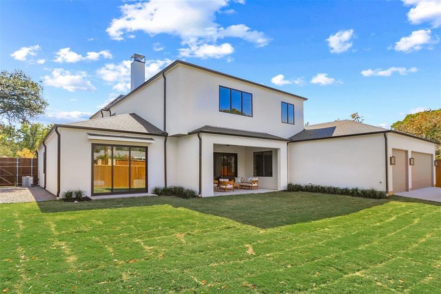 Rear view of property with a patio area and a lawn