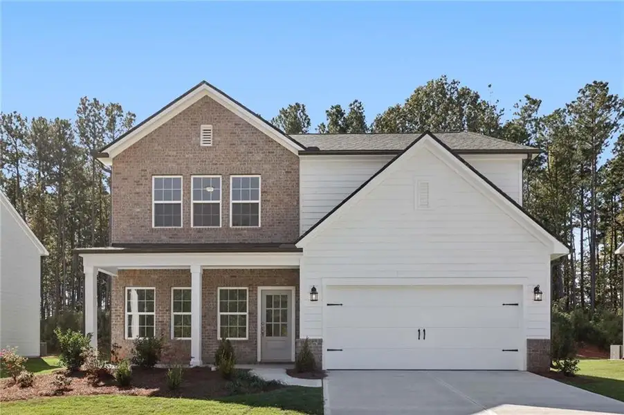 Front exterior of a new home in The Pointe at Heron Bay, Locust Grove, GA, highlighting curb appeal (Image 1).