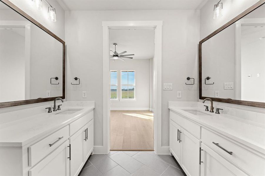 Bathroom with tile patterned flooring, vanity, and ceiling fan