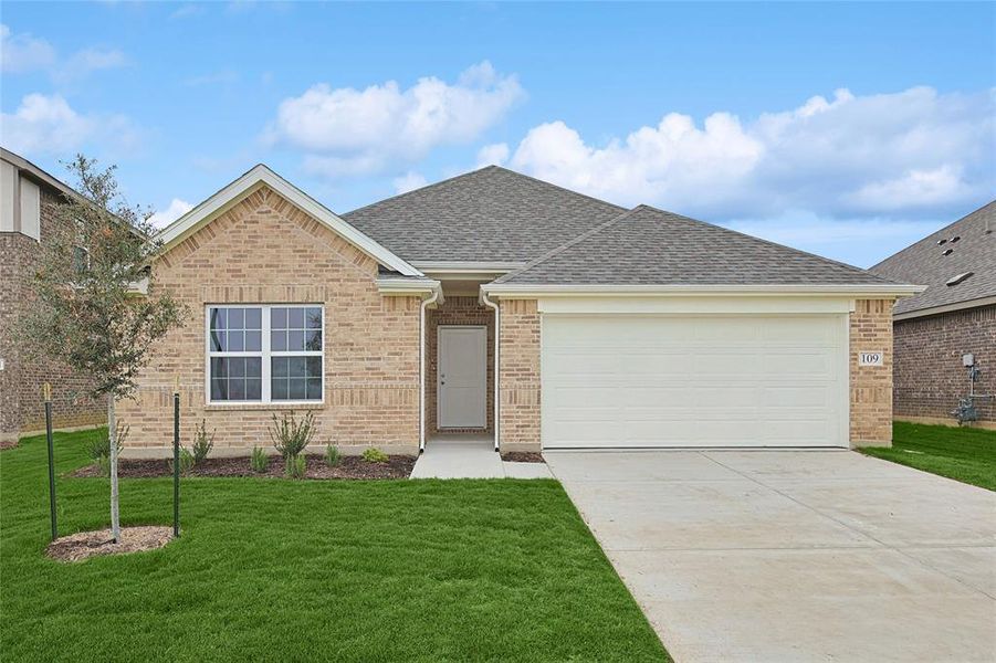 View of front of home featuring a front yard and a garage