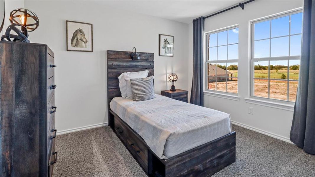 Bedroom with dark colored carpet