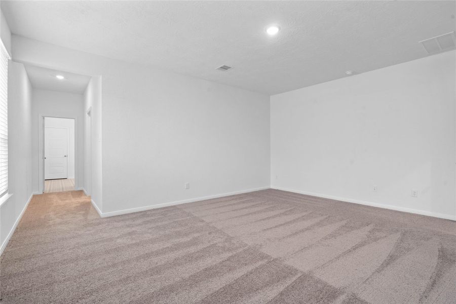 Additional view from primary suite to walk-in closet and primary bathroom