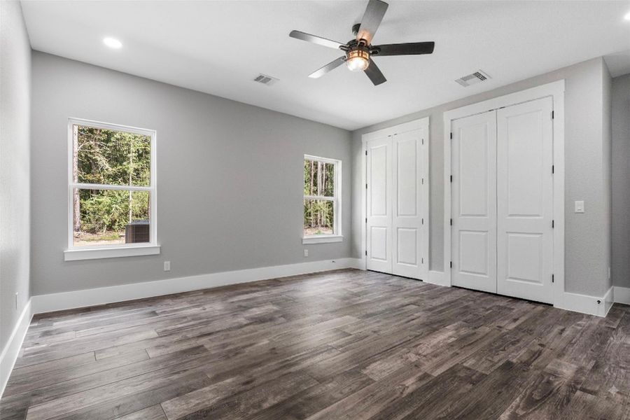 Huge secondary bedroom that is secluded featuring dual closets for ample storage.