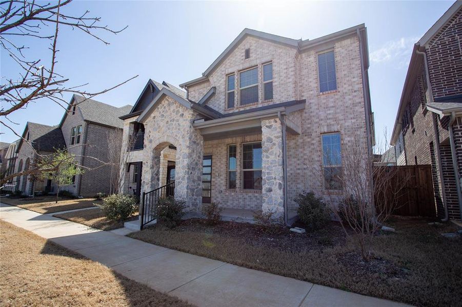 View of front of property featuring brick siding and stone siding