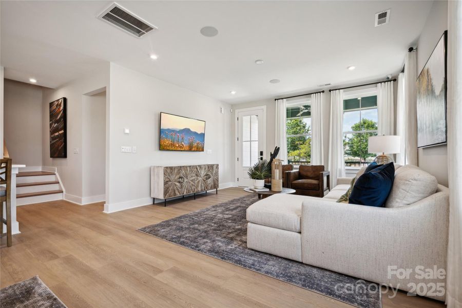 Great room elevated by 9' ceilings and bright open windows. *Model Photos | actual finishes, structural selections, and orientation may vary.