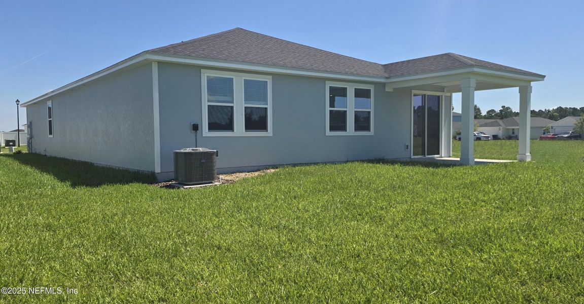 Front exterior of a new home in Lakes at Bella Lago - Signature Series, Green Cove Springs, FL, highlighting curb appeal (Image 19).