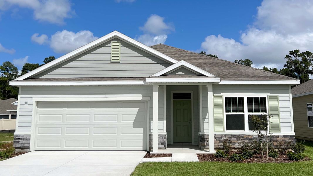 Front exterior of a new home in Oaks Preserve, Gainesville, FL, highlighting curb appeal (Image 1).