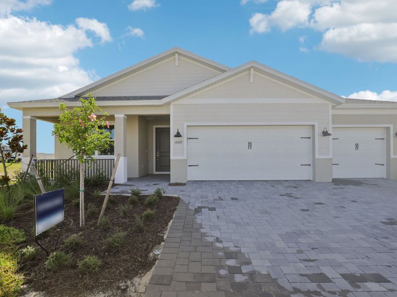 Front exterior of a new home in Crescent Lakes - Signature Series, Punta Gorda, FL, highlighting curb appeal (Image 1).
