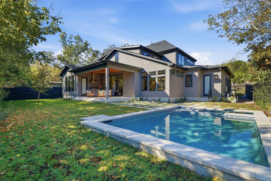 Rear view of property featuring a fenced backyard, a patio area, and stucco siding