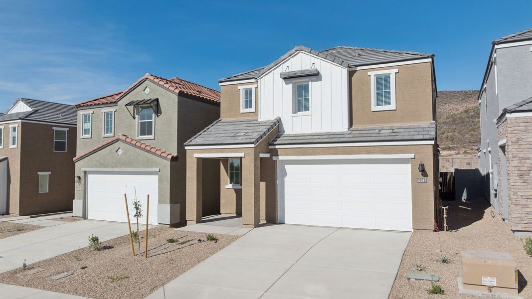 Front exterior of a new home in The Buttes at Mystic, Peoria, AZ, highlighting curb appeal (Image 27). Front exterior of a new home in The Buttes at Mystic, Peoria, AZ, highlighting curb appeal (Image 27).