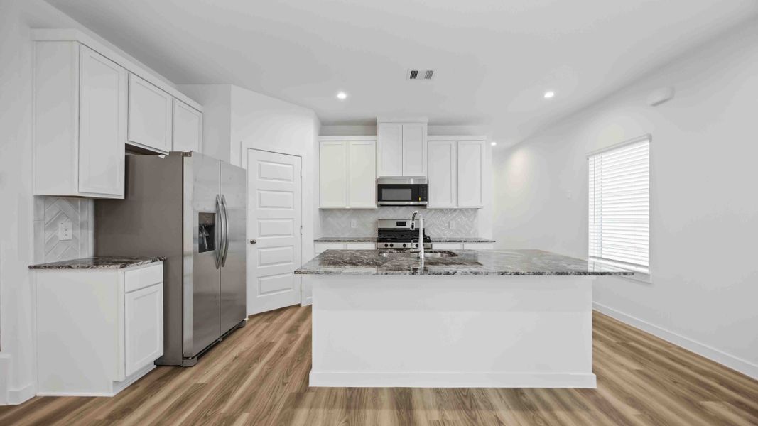 Representative furnished interior of a home built from the Magnolia by D.R. Horton in Grand West, Houston (Image 6).