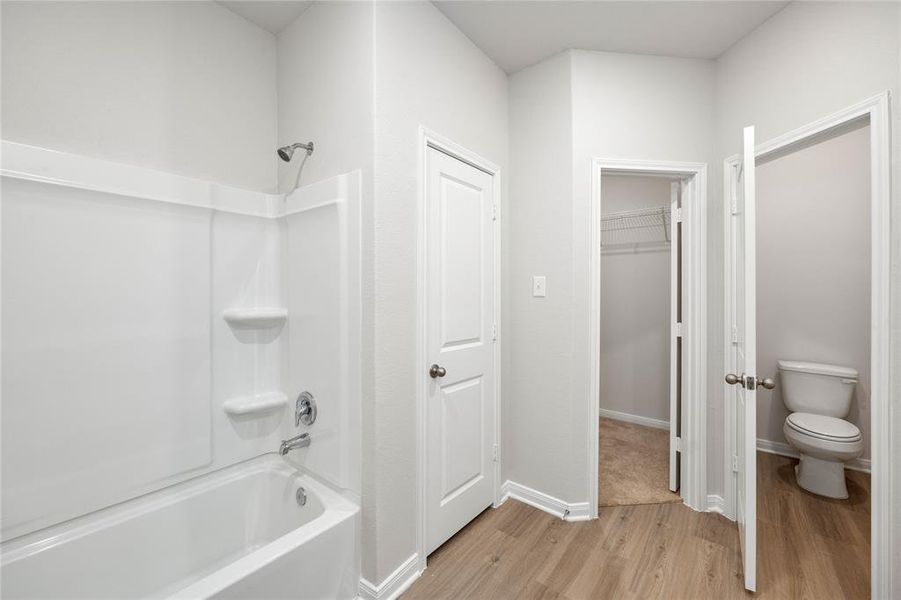 Luxurious primary bathroom with walk-in closets.