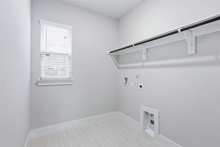 Downstairs laundry room conveniently located off the hallway leading to the garage.
