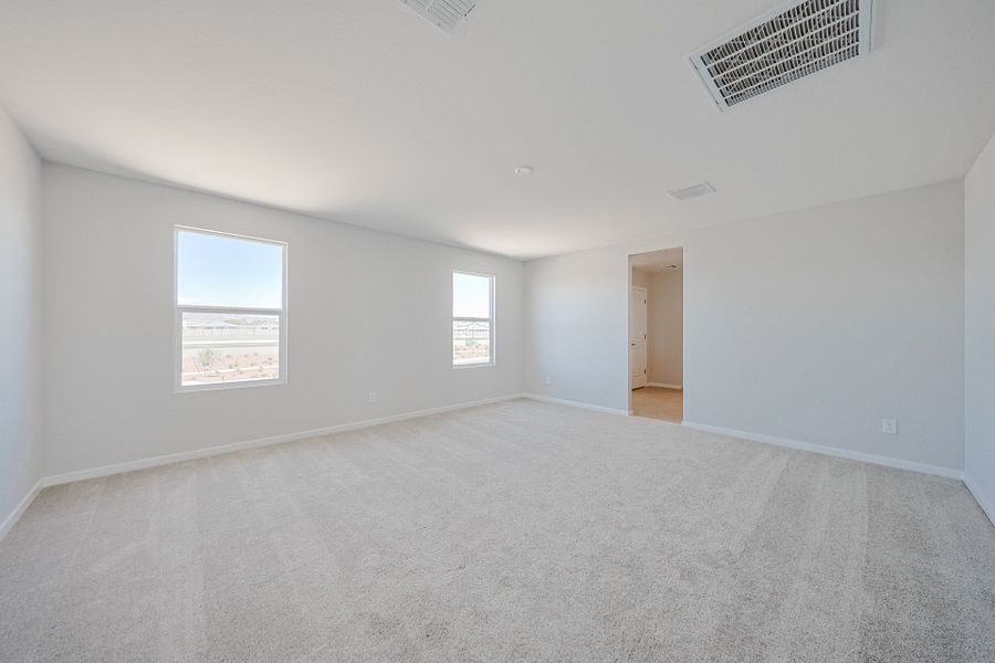 A room with a carpet and windows. A room with a carpet and windows.