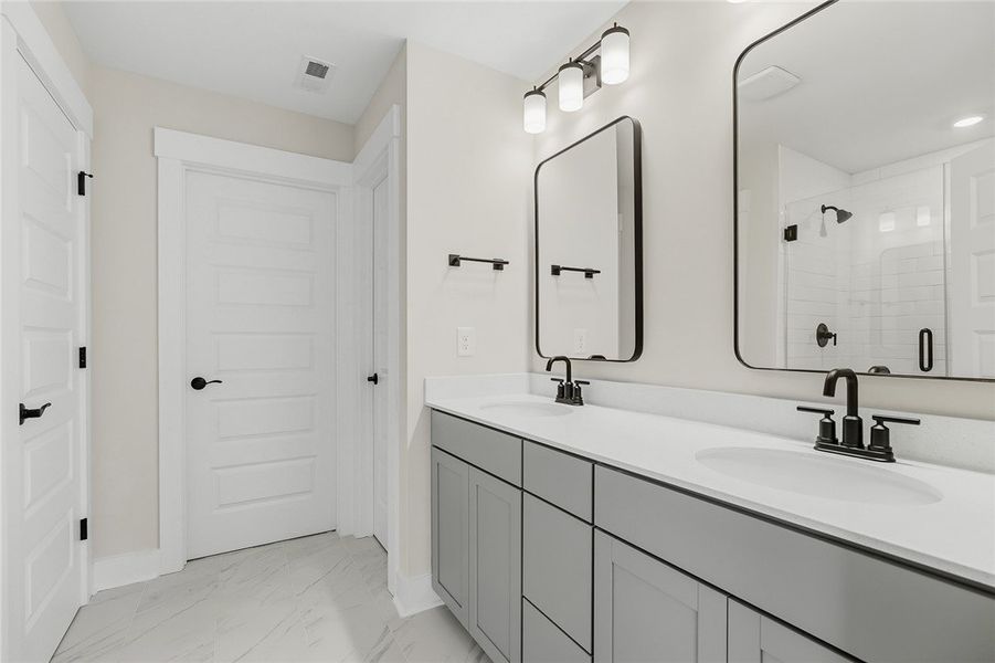 Clean lines and a spacious dual vanity define this