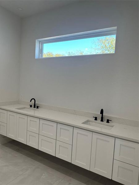 Bathroom featuring tile patterned flooring and vanity