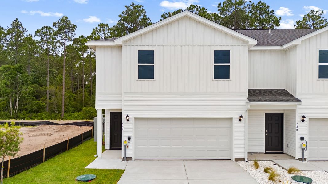 Front exterior of a new home in Chateau Nemours, Port Saint Joe, FL, highlighting curb appeal (Image 1). Front exterior of a new home in Chateau Nemours, Port Saint Joe, FL, highlighting curb appeal (Image 1).