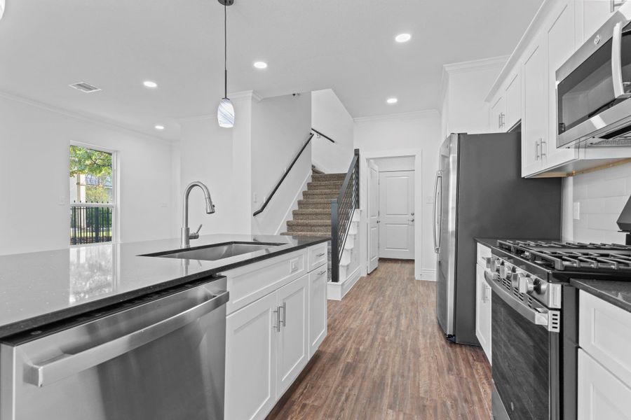This view showcases the long stretch of cabinetry and sparkling countertops which give you so much space for preparing meals and keeping everything tidy. The natural light makes the kitchen feel cheerful and open. This view showcases the long stretch of cabinetry and sparkling countertops which give you so much space for preparing meals and keeping everything tidy. The natural light makes the kitchen feel cheerful and open.