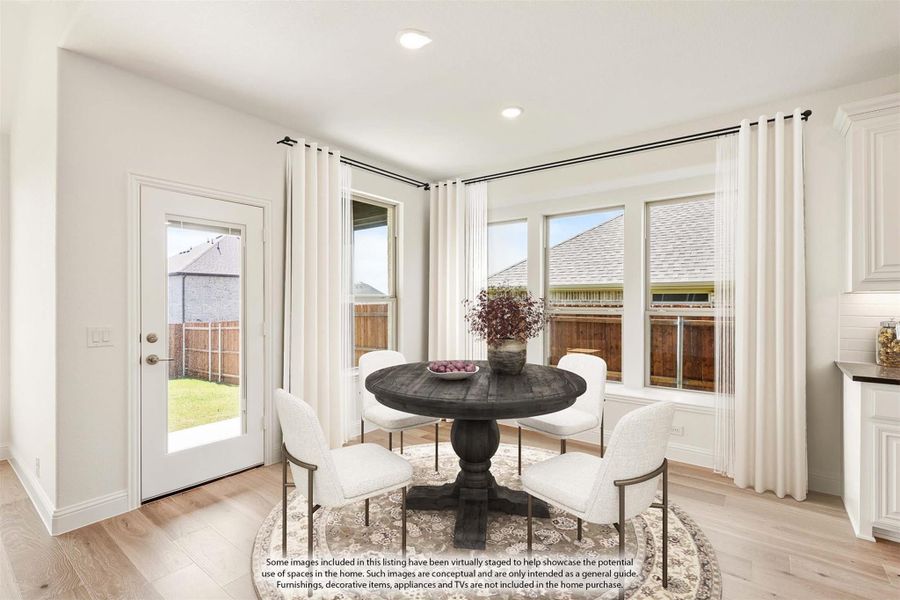 Bright breakfast nook with round dark wood table, white chairs, bay windows, and backyard door access. Bright breakfast nook with round dark wood table, white chairs, bay windows, and backyard door access.